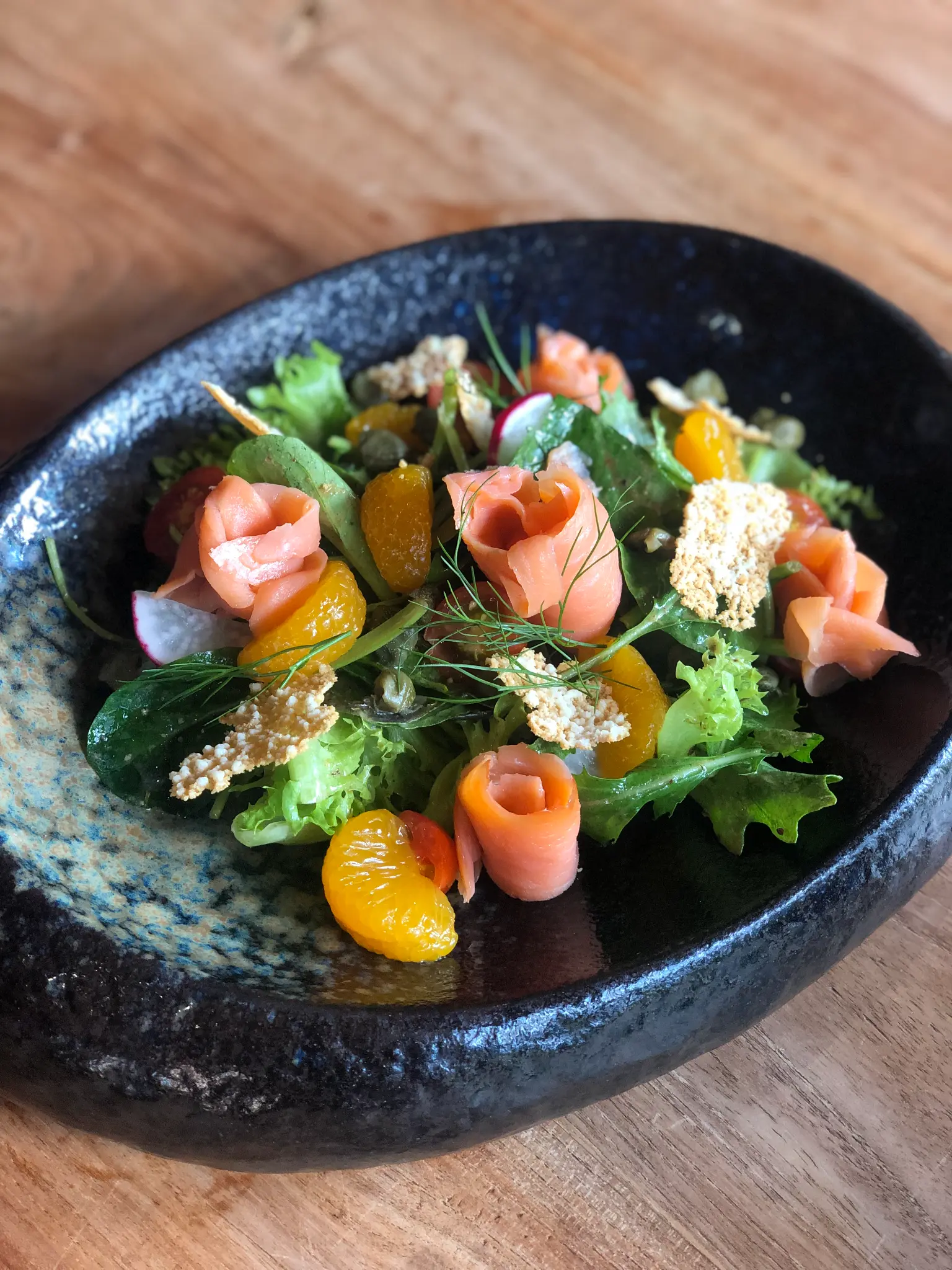 Garden salad with bright vegetables. Garden greens, tomato and colourful vegetable details create a fresh composed plate.