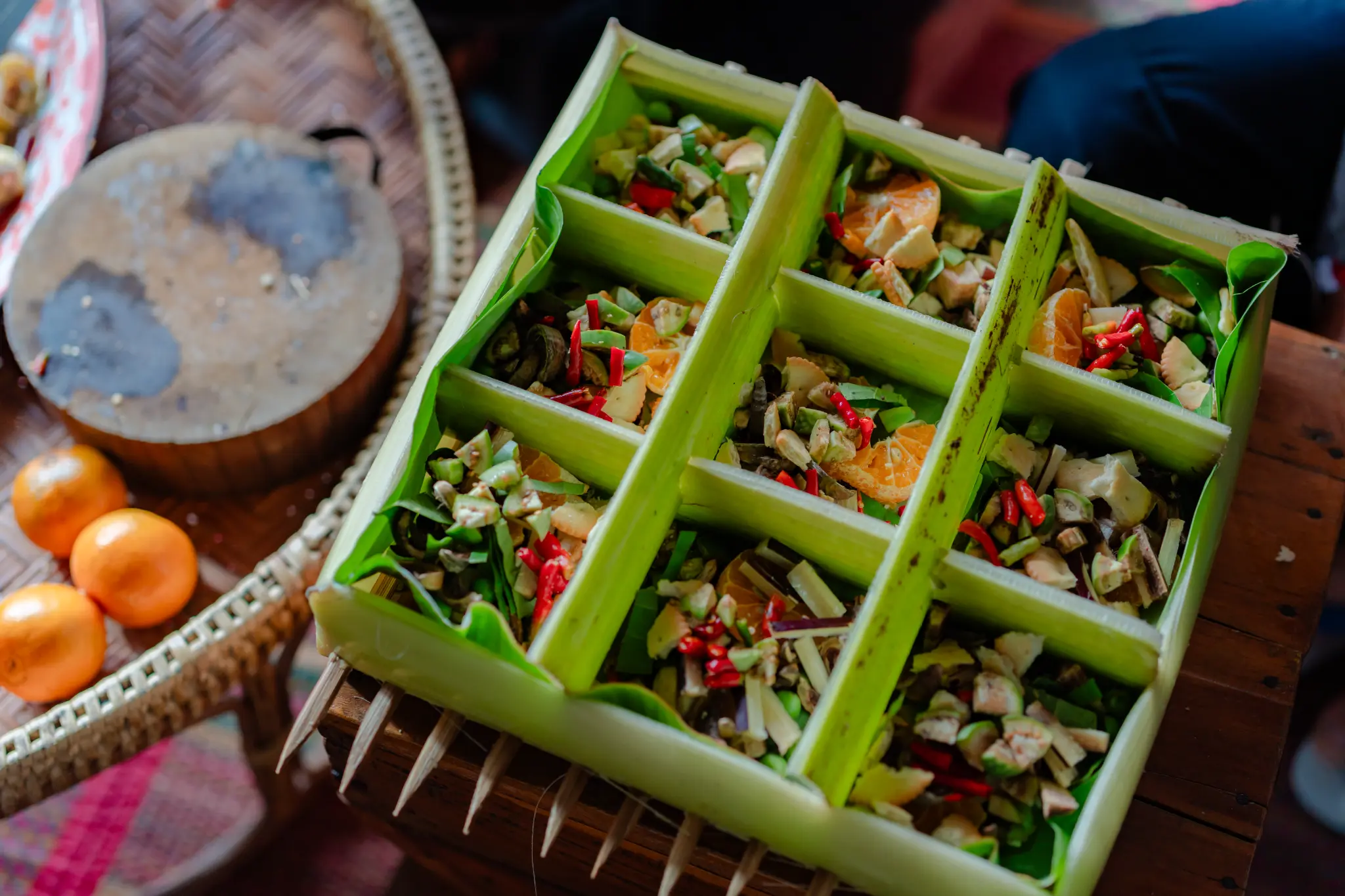Traditional snack ingredients carefully arranged in a banana-leaf container